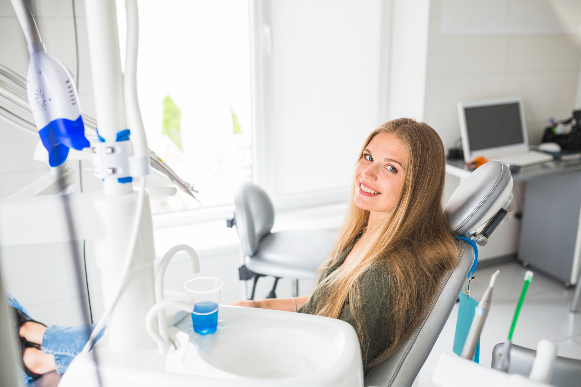 happy young woman in dentist chair
